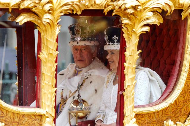 (FILES) Britain's King Charles III and Britain's Queen Camilla (R) travel in the Gold State Coach back to Buckingham Palace from Westminster Abbey in central London on May 6, 2023, after their coronations. Britain's King Charles III is expected to reveal his personal tax bill in a bid to improve transparency on June 25, 2026, as royal finances come under increasing public scrutiny in Britain. (Photo by Odd ANDERSEN / AFP)