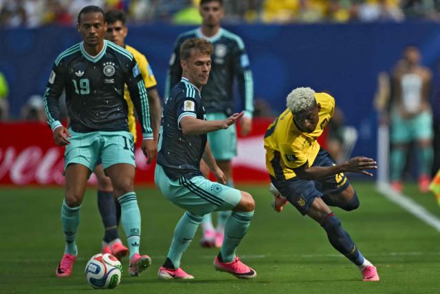 Germany's defender #06 Joshua Kimmich and Ecuador's forward #20 Nilson Angulo fight for the ball during the 2026 World Cup Group E football match between Ecuador and Germany at the New York/New Jersey Stadium in East Rutherford on June 25, 2026. (Photo by MAURO PIMENTEL / AFP)