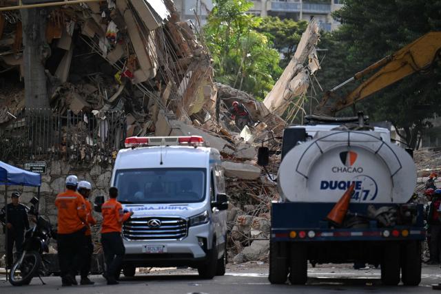 Rescuers and paramedics work at the site of a collapsed building as emergency vehicles stand nearby in Caracas on June 25, 2026, following an earthquake. The death toll from twin quakes, measured at magnitudes 7.2 and 7.5, has risen to at least 188, with more than 1,520 others injured, top lawmaker Jorge Rodriguez reported, while residents continue searching for missing relatives. (Photo by Juan BARRETO / AFP)