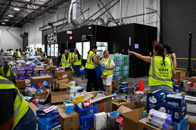Volunteers assemble, sort and pack donations bound for Venezuela as relief organizations work to deliver emergency supplies after two major earthquakes hit northern Venezuela, at the Global Empowerment Mission headquarters in Miami, Florida, on June 25, 2026. (Photo by CHANDAN KHANNA / AFP)