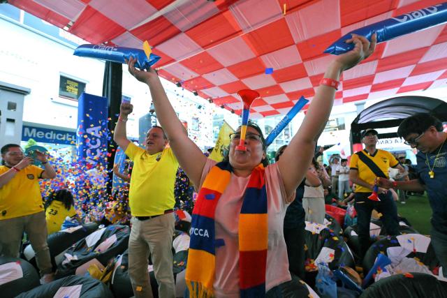 Fans of Ecuador celebrate at a Fan Fest in northern Quito, on June 25, 2026 after their team defeated Germany 2-1 and squeezed into the last 32 of the FIFA World Cup. (Photo by Rodrigo BUENDIA / AFP)