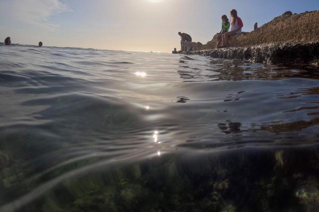 Young people swim off the coast of the Miramar neighborhood in Havana on June 24, 2026. (Photo by Pablo PORCIUNCULA / AFP)
