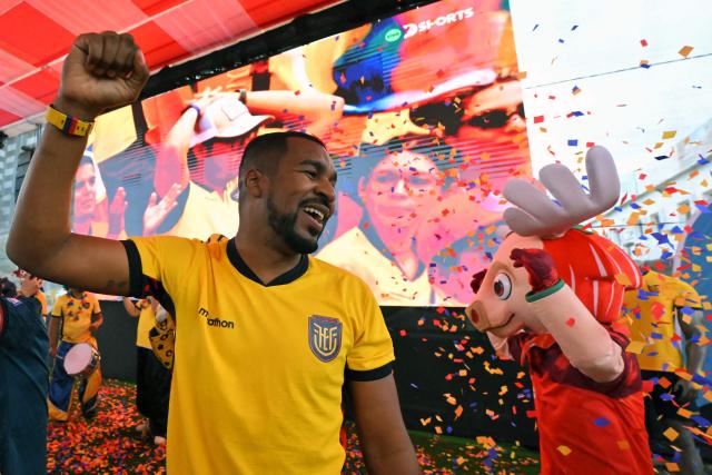 A fan of Ecuador celebrates at a Fan Fest in northern Quito, on June 25, 2026 after his team scored to defeat Germany 2-1 and squeezed into the last 32 of the FIFA World Cup. (Photo by Rodrigo BUENDIA / AFP)