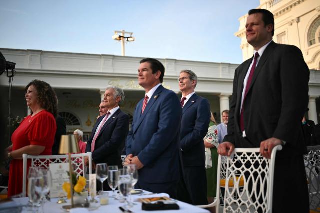 US Secretary of Treasury Scott Bessent (2R), Medicare and Medicaid Administrator Mehmet Oz (3L) listen to US President Donald Trump (off frame)  speak during a Rose Garden Club dinner with American farmers at the White House in Washington, DC, on June 25, 2026. (Photo by Mandel NGAN / AFP)