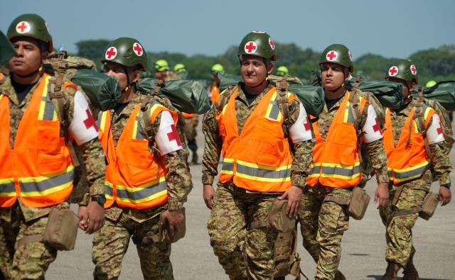 Salvadorean military members get ready to board a plane heading to Venezuela, at Comalapa Air Base in San Luis Talpa, El Salvador, on June 25, 2026. A first plane carrying a 300-member team of rescuers and experts, as well as food supplies, was sent to Venezuela to assist after the devastating June 24 twin earthquakes. (Photo by Rudy QUIROZ / AFP)
