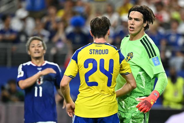 Sweden's goalkeeper #01 Jacob Widell Zetterstrom celebrates with teammate midfielder #24 Elliot Stroud after a save during the 2026 World Cup Group F football match between Japan and Sweden at the Dallas Stadium in Arlington on June 25, 2026.  (Photo by Paul ELLIS / AFP)