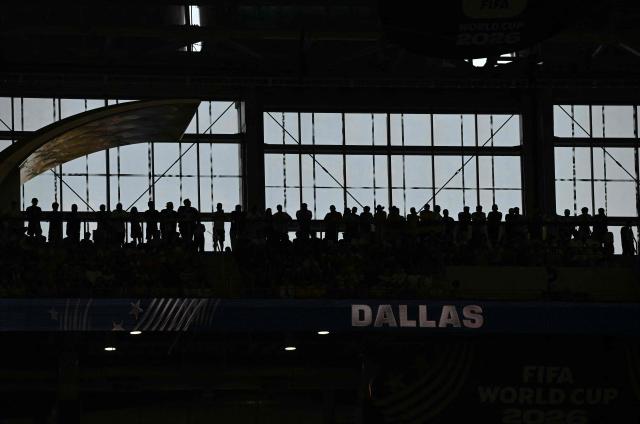 Silhouettes of fans on the stands are seen during the 2026 World Cup Group F football match between Japan and Sweden at the Dallas Stadium in Arlington on June 25, 2026.  (Photo by Paul ELLIS / AFP)