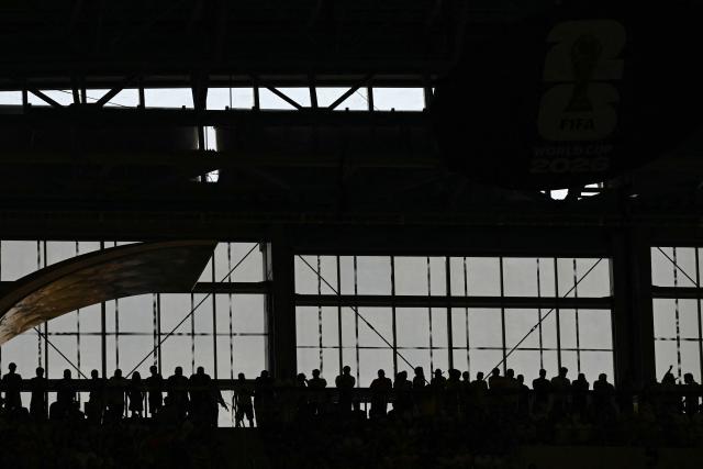 Silhouettes of fans on the stands are seen during the 2026 World Cup Group F football match between Japan and Sweden at the Dallas Stadium in Arlington on June 25, 2026.  (Photo by Paul ELLIS / AFP)