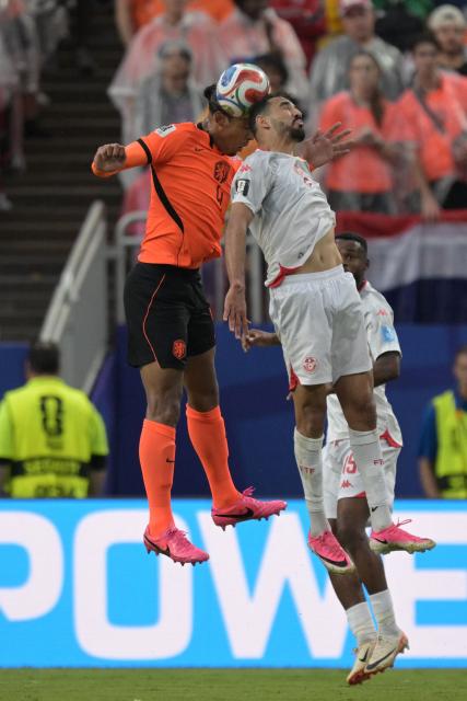 Netherlands' defender #04 Virgil van Dijk (L) and Tunisia's forward #09 Hazem Mastouri fight for the ball during the 2026 World Cup Group F football match between Tunisia and the Netherlands at the Kansas City Stadium in Kansas City on June 25, 2026.  (Photo by Juan MABROMATA / AFP)