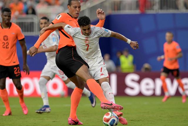 Netherlands' defender #04 Virgil van Dijk and Tunisia's forward #07 Elias Achouri fight for the ball during the 2026 World Cup Group F football match between Tunisia and the Netherlands at the Kansas City Stadium in Kansas City on June 25, 2026.  (Photo by Juan MABROMATA / AFP)