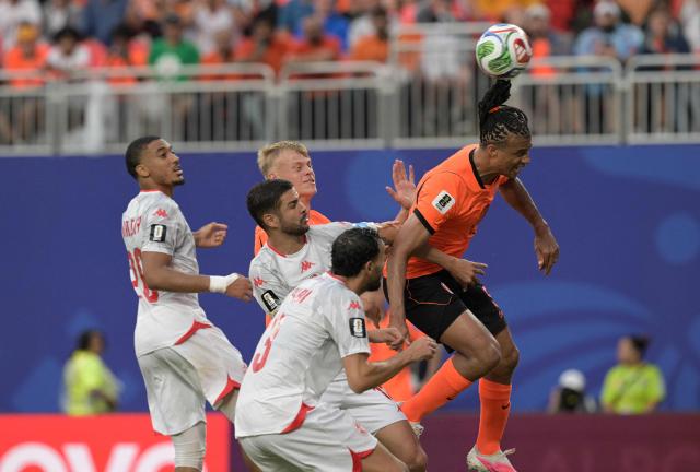 Netherlands' defender #05 Nathan Ake (L) heads the ball during the 2026 World Cup Group F football match between Tunisia and the Netherlands at the Kansas City Stadium in Kansas City on June 25, 2026.  (Photo by Juan MABROMATA / AFP)