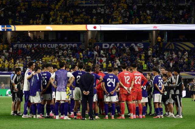 Japan's players celebrate at the end of the 2026 World Cup Group F football match between Japan and Sweden at the Dallas Stadium in Arlington on June 25, 2026.  (Photo by Aric Becker / AFP)