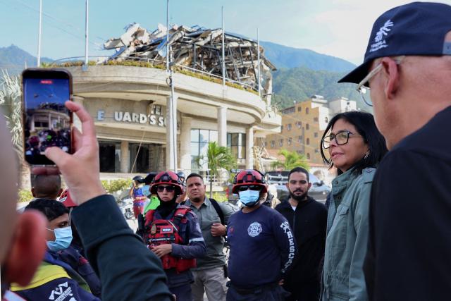 Handout picture released by the Venezuelan presidency press office showing Venezuela's interim President Delcy Rodriguez (C) and Venezuela's National Assembly President Jorge Rodriguez visiting the area strongly affected by the earthquake in La Guaira, on June 25, 2026. Desperate Venezuelans raced to find and rescue loved ones trapped alive beneath the rubble of collapsed buildings after two major earthquakes --measured at magnitudes 7.2 and 7.5-- hit northern Venezuela killing at least 235 people and leaving more than 1,500 injured. (Photo by Handout / Venezuelan Presidency / AFP)