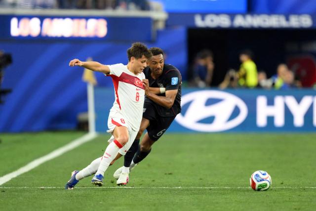 Turkey's midfielder #08 Arda Guler and US defender #06 Auston Trusty fight for the ball during the 2026 World Cup Group D football match between Turkey and USA at the Los Angeles Stadium in Inglewood on June 25, 2026.  (Photo by Patrick T. FALLON / AFP)