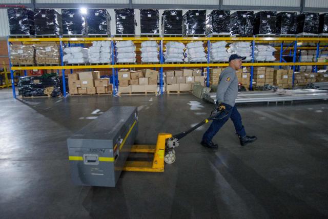 A Colombian firefighter prepares equipment before departing with humanitarian aid to Venezuela at Catam Air Base in Bogota on June 25, 2026, following deadly earthquakes. Desperate Venezuelans raced to find and rescue loved ones trapped alive beneath the rubble of collapsed buildings after two major earthquakes, measured at magnitudes 7.2 and 7.5, hit northern Venezuela killing at least 235 people and leaving more than 1,500 injured. (Photo by Sebastian BARROS / AFP)