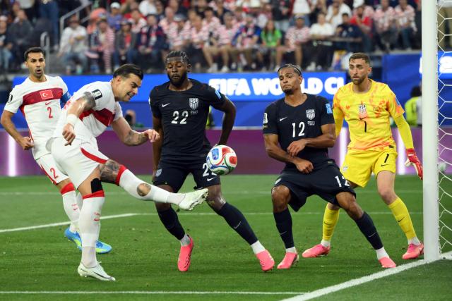 Turkey's defender #14 Abdulkerim Bardakci (L) kicks the ball during the 2026 World Cup Group D football match between Turkey and USA at the Los Angeles Stadium in Inglewood on June 25, 2026.  (Photo by Patrick T. FALLON / AFP)