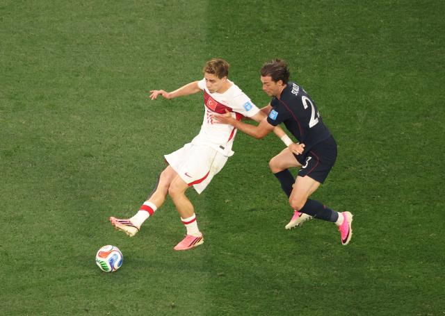 Turkey's forward #11 Kenan Yildiz and US defender #23 Joe Scally fight for the ball during the 2026 World Cup Group D football match between Turkey and USA at the Los Angeles Stadium in Inglewood on June 25, 2026.  (Photo by Etienne LAURENT / AFP)