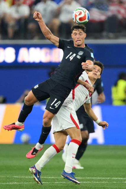 US midfielder #14 Sebastian Berhalter and Turkey's midfielder #08 Arda Guler during the 2026 World Cup Group D football match between Turkey and USA at the Los Angeles Stadium in Inglewood on June 25, 2026.  (Photo by Patrick T. FALLON / AFP)
