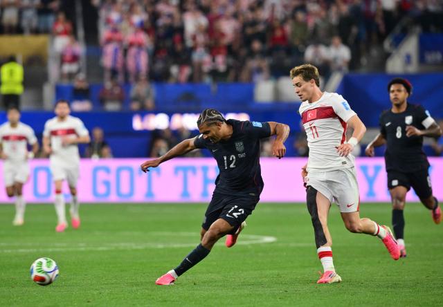 US defender #12 Miles Robinson and Turkey's forward #11 Kenan Yildiz fight for the ball during the 2026 World Cup Group D football match between Turkey and USA at the Los Angeles Stadium in Inglewood on June 25, 2026.  (Photo by Frederic J. BROWN / AFP)