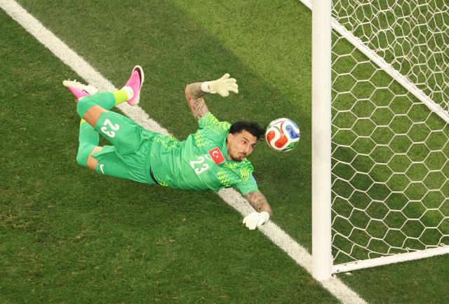 Turkey's goalkeeper #23 Ugurcan Cakir dives for the ball during the 2026 World Cup Group D football match between Turkey and USA at the Los Angeles Stadium in Inglewood on June 25, 2026.  (Photo by Etienne LAURENT / AFP)