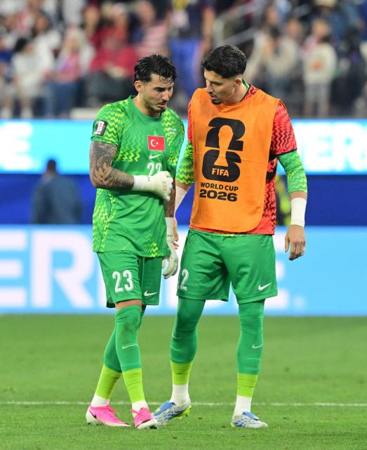 Turkey's goalkeeper #23 Ugurcan Cakir (L) reacts next to goalkeeper #12 Altay Bayindir during the 2026 World Cup Group D football match between Turkey and USA at the Los Angeles Stadium in Inglewood on June 25, 2026.  (Photo by Patrick T. FALLON / AFP)