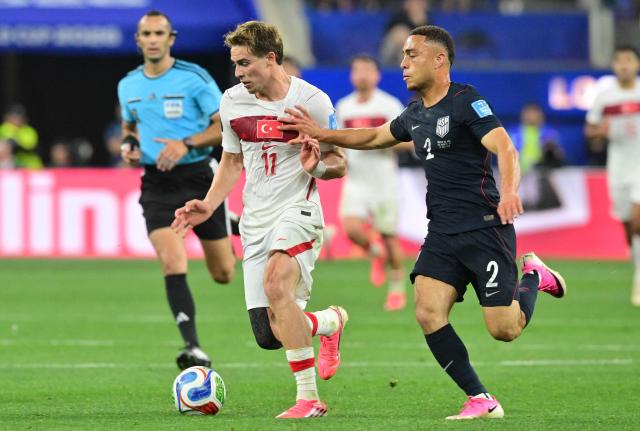 Turkey's forward #11 Kenan Yildiz and US defender #02 Sergino Dest fight for the ball during the 2026 World Cup Group D football match between Turkey and USA at the Los Angeles Stadium in Inglewood on June 25, 2026.  (Photo by Frederic J. BROWN / AFP)