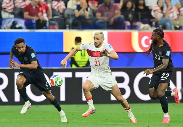 US defenders #06 Auston Trusty, #22 Mark McKenzie and Turkey's forward #21 Baris Alper Yilmaz fight for the ball during the 2026 World Cup Group D football match between Turkey and USA at the Los Angeles Stadium in Inglewood on June 25, 2026.  (Photo by Frederic J. Brown / AFP)