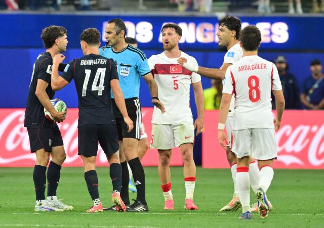 Argelian referee Mustapha Ghorbal talks to US forward #10 Christian Pulisic (L) during the 2026 World Cup Group D football match between Turkey and USA at the Los Angeles Stadium in Inglewood on June 25, 2026.  (Photo by Frederic J. Brown / AFP)