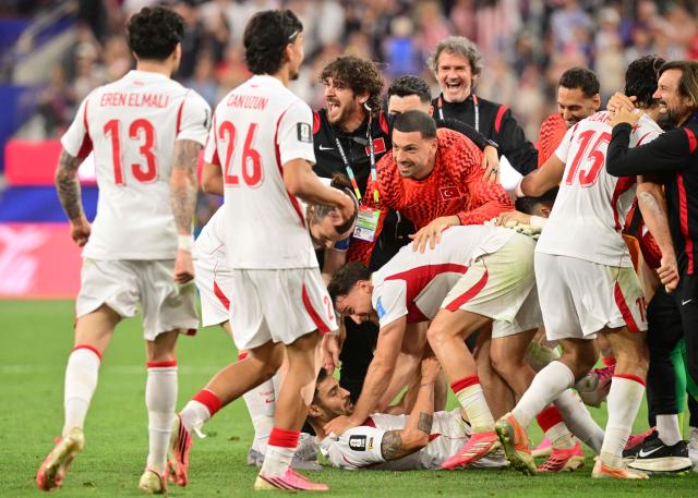 Turkey's defender #22 Kaan Ayhan (C) celebrates after scoring his team’s third goal with teammates during the 2026 World Cup Group D football match between Turkey and USA at the Los Angeles Stadium in Inglewood on June 25, 2026.  (Photo by Frederic J. BROWN / AFP)