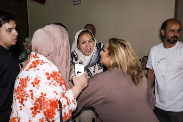 Family members of Said Naciri and Abdennabi Bioui, two Moroccan public figures, react as they are handed out 10 and 12 years in prison sentences over a  major drug trafficking scheme linked to a convicted Malian kingpin, dubbed the "Escobar of the Sahara" case, at the Court of Appeals in Casablanca on June 25, 2026. The case implicates more than 20 people accused of having played a role in the pervasive international drug network ran by Ahmed Ben Brahim. Naciri and Bioui, both former senior officials of the Authenticity and Modernity Party -- a group that is part of the governing coalition in Morocco, were charged for corruption, forgery and the "possession, sale and export of drugs". (Photo by Abdel Majid BZIOUAT / AFP)