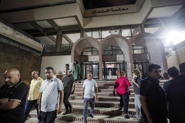 Family members of Said Naciri and Abdennabi Bioui, two Moroccan public figures sentenced to 10 and 12 years in prison over a major drug trafficking scheme linked to a convicted Malian kingpin, dubbed the "Escobar of the Sahara" case, depart from the Court of Appeals in Casablanca on June 25, 2026. The case implicates more than 20 people accused of having played a role in the pervasive international drug network ran by Ahmed Ben Brahim. Naciri and Bioui, both former senior officials of the Authenticity and Modernity Party -- a group that is part of the governing coalition in Morocco, were charged for corruption, forgery and the "possession, sale and export of drugs". (Photo by Abdel Majid BZIOUAT / AFP)