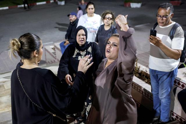 Family members of Said Naciri and Abdennabi Bioui, two Moroccan public figures sentenced to 10 and 12 years in prison over a major drug trafficking scheme linked to a convicted Malian kingpin, dubbed the "Escobar of the Sahara" case, react as they depart from the Court of Appeals in Casablanca on June 25, 2026. The case implicates more than 20 people accused of having played a role in the pervasive international drug network ran by Ahmed Ben Brahim. Naciri and Bioui, both former senior officials of the Authenticity and Modernity Party -- a group that is part of the governing coalition in Morocco, were charged for corruption, forgery and the "possession, sale and export of drugs". (Photo by Abdel Majid BZIOUAT / AFP)