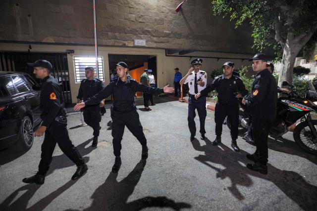 Policemen clear the area as Said Naciri and Abdennabi Bioui, two Moroccan public figures sentenced to 10 and 12 years in prison over a major drug trafficking scheme linked to a convicted Malian kingpin, dubbed the "Escobar of the Sahara" case, are transferred to Oukacha Prison in Casablanca on June 25, 2026. The case implicates more than 20 people accused of having played a role in the pervasive international drug network ran by Ahmed Ben Brahim. Naciri and Bioui, both former senior officials of the Authenticity and Modernity Party -- a group that is part of the governing coalition in Morocco, were charged for corruption, forgery and the "possession, sale and export of drugs". (Photo by Abdel Majid BZIOUAT / AFP)