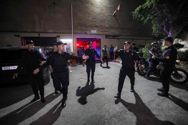 Policemen clear the area as Said Naciri and Abdennabi Bioui, two Moroccan public figures sentenced to 10 and 12 years in prison over a major drug trafficking scheme linked to a convicted Malian kingpin, dubbed the "Escobar of the Sahara" case, are transferred to Oukacha Prison in Casablanca on June 25, 2026. The case implicates more than 20 people accused of having played a role in the pervasive international drug network ran by Ahmed Ben Brahim. Naciri and Bioui, both former senior officials of the Authenticity and Modernity Party -- a group that is part of the governing coalition in Morocco, were charged for corruption, forgery and the "possession, sale and export of drugs". (Photo by Abdel Majid BZIOUAT / AFP)