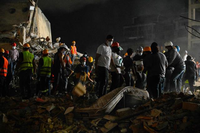 Rescue workers and volunteers search through the rubble of a collapsed building in Caracas on June 25, 2026, following a series of earthquakes. Desperate Venezuelans raced to find and rescue loved ones trapped alive beneath the rubble of collapsed buildings after two major earthquakes, measured at magnitudes 7.2 and 7.5, hit northern Venezuela killing at least 235 people and leaving more than 1,500 injured. (Photo by Maryorin Mendez / AFP)