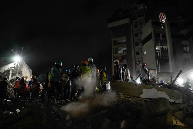 Rescue workers and volunteers search through the rubble of a collapsed building in Caracas on June 25, 2026, following a series of earthquakes. Desperate Venezuelans raced to find and rescue loved ones trapped alive beneath the rubble of collapsed buildings after two major earthquakes, measured at magnitudes 7.2 and 7.5, hit northern Venezuela killing at least 235 people and leaving more than 1,500 injured. (Photo by Maryorin Mendez / AFP)