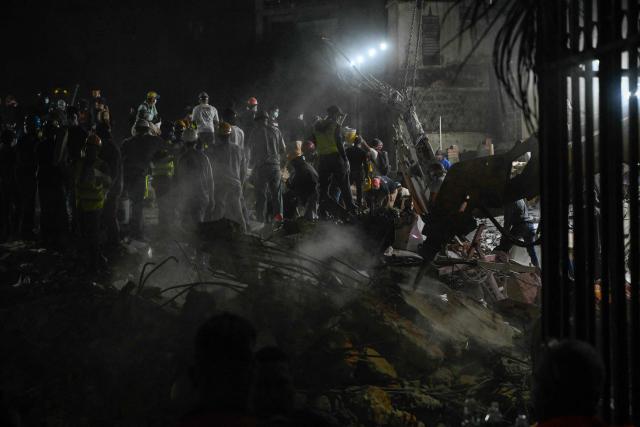 Rescue workers and volunteers search through the rubble of a collapsed building in Caracas on June 25, 2026, following a series of earthquakes. Desperate Venezuelans raced to find and rescue loved ones trapped alive beneath the rubble of collapsed buildings after two major earthquakes, measured at magnitudes 7.2 and 7.5, hit northern Venezuela killing at least 235 people and leaving more than 1,500 injured. (Photo by Maryorin Mendez / AFP)