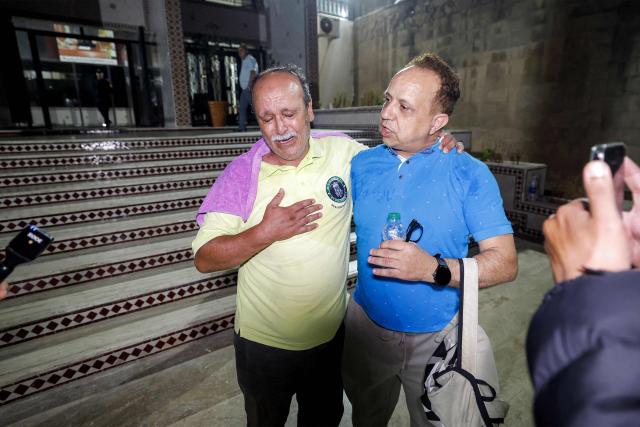 Nasr Eddine Benabid (L), a former defendant who was acquitted in a major drug trafficking scheme linked to a convicted Malian kingpin, dubbed the "Escobar of the Sahara" case, departs with his lawyer from the Court of Appeals in Casablanca on June 25, 2026. The case implicates more than 20 people accused of having played a role in the pervasive international drug network ran by Ahmed Ben Brahim. The trial, which began in 2024, is the first in Morocco involving high-profile political figures in a drug trafficking case. (Photo by Abdel Majid BZIOUAT / AFP)