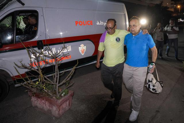 Nasr Eddine Benabid (L), a former defendant who was acquitted in a major drug trafficking scheme linked to a convicted Malian kingpin, dubbed the "Escobar of the Sahara" case, departs with his lawyer from the Court of Appeals in Casablanca on June 25, 2026. The case implicates more than 20 people accused of having played a role in the pervasive international drug network ran by Ahmed Ben Brahim. The trial, which began in 2024, is the first in Morocco involving high-profile political figures in a drug trafficking case. (Photo by Abdel Majid BZIOUAT / AFP)
