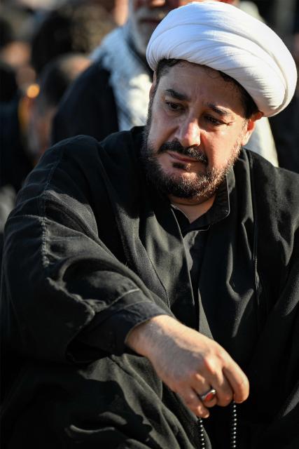 A Shia Muslim cleric reacts during a mourning ritual near the shrine of Hassan Nasrallah, the slain leader of the Lebanese Shia movement Hezbollah who was killed in a 2024 Israeli-airstrike, in Beirut’s southern suburbs on June 26, 2026 at the peak of Ashura, a 10-day period commemorating the seventh century killing of Prophet Mohammed's grandson Imam Hussein. (Photo by JOSEPH EID / AFP)