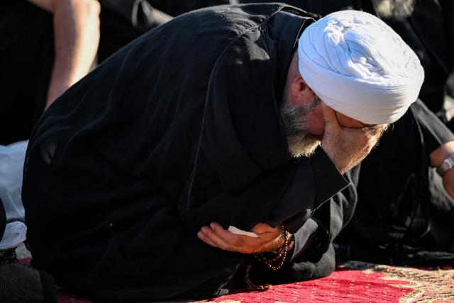 A Shia Muslim cleric reacts during a mourning ritual near the shrine of Hassan Nasrallah, the slain leader of the Lebanese Shia movement Hezbollah who was killed in a 2024 Israeli-airstrike, in Beirut’s southern suburbs on June 26, 2026 at the peak of Ashura, a 10-day period commemorating the seventh century killing of Prophet Mohammed's grandson Imam Hussein. (Photo by JOSEPH EID / AFP)