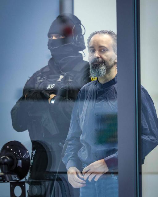 Saudi Arabian defendant Taleb Jawad al-Abdulmohsen (R) is led by judicial officers to the temporary courtroom in Magdeburg, eastern Germany on June 26, 2026, before his trial for driving an SUV through a crowd at a Christmas market. The court sentenced to life in jail the Saudi psychiatrist who drove an SUV through a crowded Christmas market in 2024, killing six people and injuring more than 300. (Photo by Ronny HARTMANN / AFP)