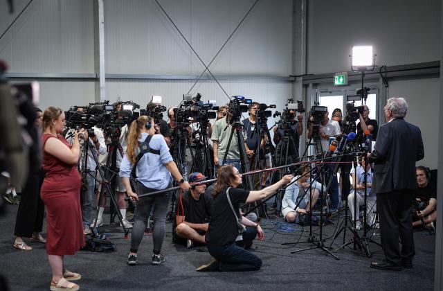 Press spokesperson for the Regional Court of Magdeburg Christian Loeffler (R) gives a press statement in the temporary courtroom in Magdeburg, eastern Germany on June 26, 2026, during the trial against Saudi Arabian defendant Taleb Jawad al-Abdulmohsen over the deadly Christmas market attack in December 2024. The court sentenced to life in jail the Saudi psychiatrist who drove an SUV through a crowded Christmas market in 2024, killing six people and injuring more than 300. (Photo by Ronny HARTMANN / AFP)