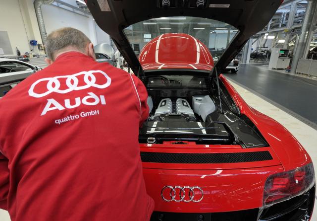 (FILES) An employee of German luxury car maker Audi works on an Audi R8 sportscar at an assembly line of the Audi plant in Neckarsulm, southwestern Germany, on February 15, 2012. According to a media report on June 26, 2026, the car manufacturer Volkswagen plans to cut up to 100,000 jobs. Four plants in Germany, including the Audi plant in Neckarsulm, are to be closed, the "Manager Magazin" reported, citing insiders. In addition, VW CEO Oliver Blume is reportedly planning to spin off the core Volkswagen brand into a new company. According to the report, the job cuts are planned worldwide. (Photo by THOMAS KIENZLE / AFP)