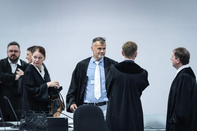 (L to R) The pool lawyers for the joint plaintiffs, Petra Kuellmei and Carsten Schneider talk to Chief Public Prosecutor Matthias Boettcher and Public Prosecutor Marco Reinl at the temporary courtroom in Magdeburg, eastern Germany, before the trial against Saudi Arabian defendant Taleb Jawad al-Abdulmohsen over the deadly Christmas market attack in December 2024. The court sentenced to life in jail the Saudi psychiatrist who drove an SUV through a crowded Christmas market in 2024, killing six people and injuring more than 300. (Photo by Ronny HARTMANN / AFP)
