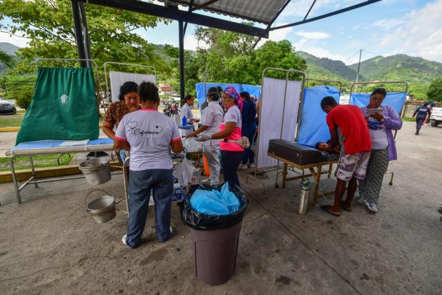 Rescue workers and paramedics set up a care center following twin earthquakes in Moron, Carabobo State on June 26, 2026. Rescuers used heavy machinery and their bare hands on June 26 in a race to save survivors of deadly twin earthquakes in Venezuela that killed at least 235 people, hurt thousands and flattened scores of buildings. (Photo by Orlando Obispo / AFP)