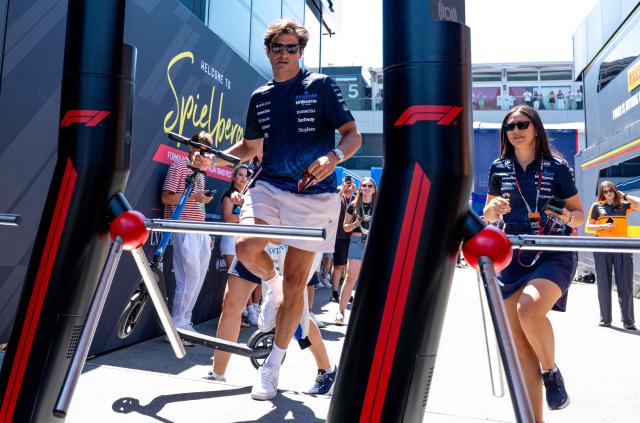 Williams' Spanish driver Carlos Sainz (L) arrives to the paddock prior to the first practice session at the Red Bull Ring race track in Spielberg, Austria on June 26, 2026, ahead of the Formula One Austrian Grand Prix. (Photo by Joe KLAMAR / AFP)