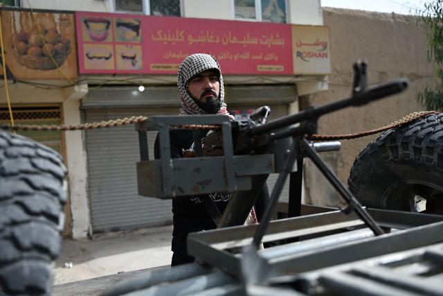 A Taliban security personnel stands guard along a road on the tenth day of Ashura, during the Islamic holy month of Muharram in Kandahar on June 26, 2026. (Photo by Sanaullah SEIAM / AFP)
