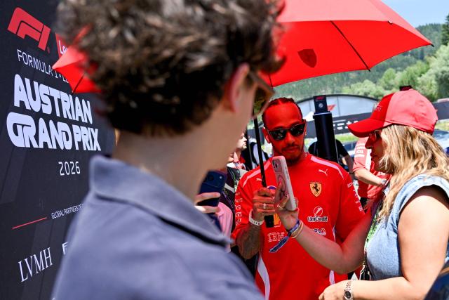 Ferrari's British driver Lewis Hamilton (C) arrives to the paddock prior to the first practice session at the Red Bull Ring race track in Spielberg, Austria on June 26, 2026, ahead of the Formula One Austrian Grand Prix. (Photo by Andrej ISAKOVIC / AFP)