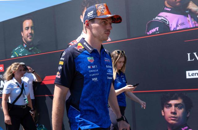 Red Bull Racing's Dutch driver Max Verstappen walks past a wall with portraits of current F1 drivers as he arrives to the paddock prior to the first practice session at the Red Bull Ring race track in Spielberg, Austria on June 26, 2026, ahead of the Formula One Austrian Grand Prix. (Photo by Joe KLAMAR / AFP)